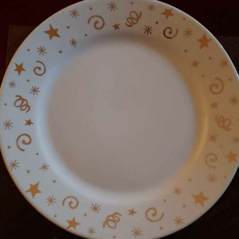 The Pampered Chef Ceramic Plates with a festive gold stars and swirls design